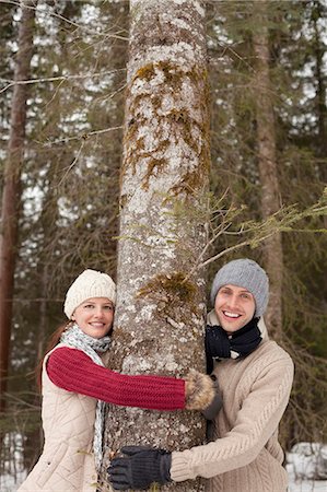 simsearch:6113-06899345,k - Portrait of happy couple hugging tree trunk in woods Stock Photo - Premium Royalty-Free, Code: 6113-06899508