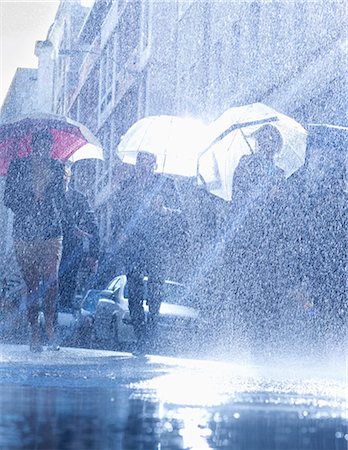 street and low angle - Business people with umbrellas in rain Stock Photo - Premium Royalty-Free, Code: 6113-06899532