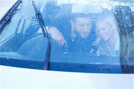 rainy day - Business people text messaging with cell phone inside car Stock Photo - Premium Royalty-Free, Code: 6113-06899638