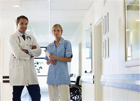 Doctor and nurse standing in hospital hallway Stock Photo - Premium Royalty-Free, Code: 6113-06908273