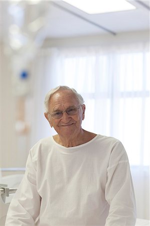 palliative care - Older patient smiling in hospital room Stock Photo - Premium Royalty-Free, Code: 6113-06908294