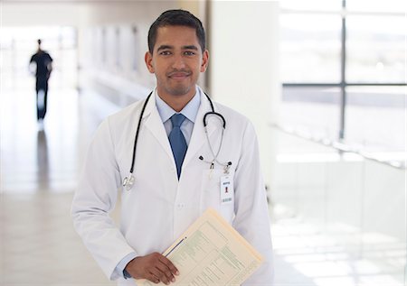 Doctor smiling in hospital hallway Stock Photo - Premium Royalty-Free, Code: 6113-06908227