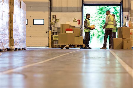 Workers talking in warehouse Stock Photo - Premium Royalty-Free, Code: 6113-06908370