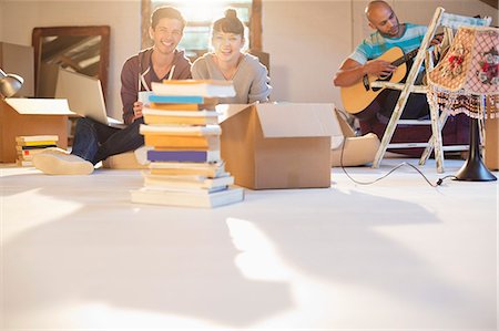 person with boxes - Friends relaxing together in new attic Stock Photo - Premium Royalty-Free, Code: 6113-06908542