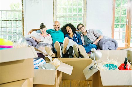 people in row - Friends relaxing together in new home Stock Photo - Premium Royalty-Free, Code: 6113-06908669