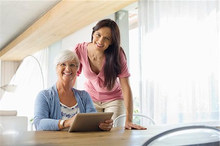 Women using tablet computer at table Stock Photo - Premium Royalty-Free, Code: 6113-06908695