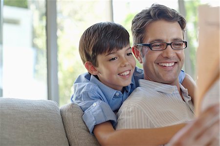 simsearch:6113-06899473,k - Father and son hugging on sofa Stock Photo - Premium Royalty-Free, Code: 6113-06908749