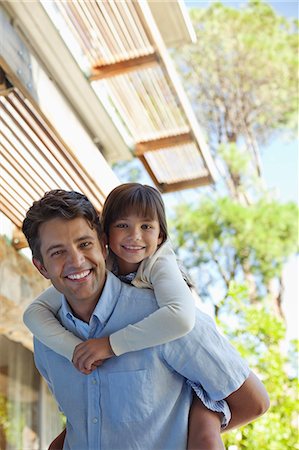 simsearch:6113-06899473,k - Father carrying daughter piggy back outdoors Stock Photo - Premium Royalty-Free, Code: 6113-06908837