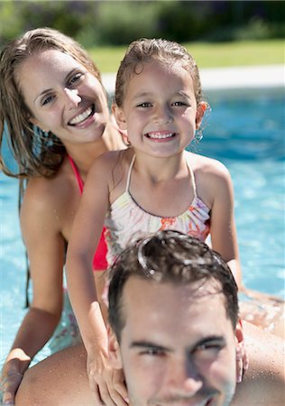 swimming, happy - Family smiling in swimming pool Stock Photo - Premium Royalty-Free, Code: 6113-06909346