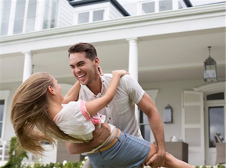 excitement outdoors - Couple playing outside house Stock Photo - Premium Royalty-Free, Code: 6113-06909441