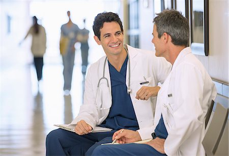 Doctors talking in hospital corridor Stock Photo - Premium Royalty-Free, Code: 6113-07146779