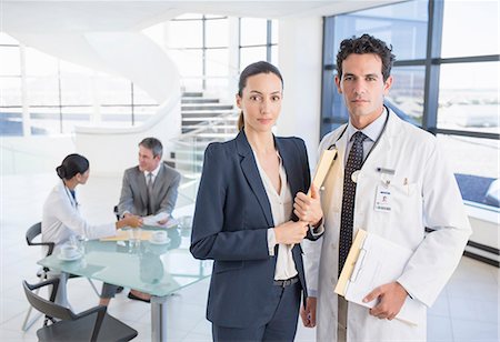 Portrait of confident doctor and businesswoman in meeting Stock Photo - Premium Royalty-Free, Code: 6113-07146792