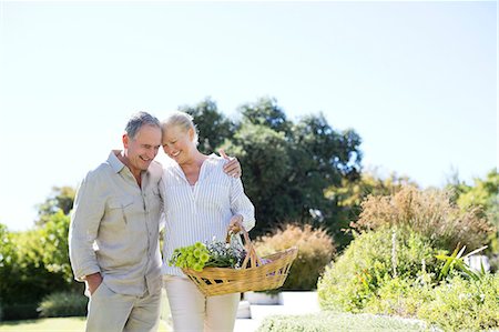 senior couple garden - Senior couple walking with basket outdoors Stock Photo - Premium Royalty-Free, Code: 6113-07146841