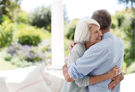 senior couple garden - Senior couple hugging on patio Stock Photo - Premium Royalty-Free, Code: 6113-07146850