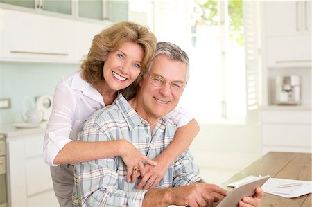 simsearch:6113-06720867,k - Portrait of smiling senior couple with digital tablet in kitchen Stock Photo - Premium Royalty-Free, Code: 6113-07146890
