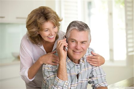 seniors using cell phone - Senior couple talking on telephone Stock Photo - Premium Royalty-Free, Code: 6113-07146947