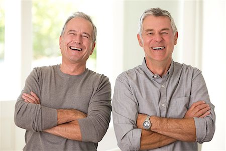Portrait of senior men laughing with arms crossed Stock Photo - Premium Royalty-Free, Code: 6113-07146908