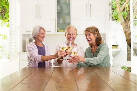 simsearch:6113-07242109,k - Senior women toasting wine glasses in kitchen Stock Photo - Premium Royalty-Free, Code: 6113-07146931
