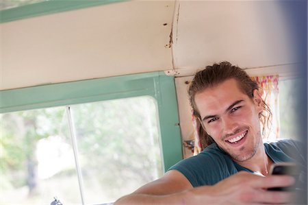 Man smiling in camper van Stock Photo - Premium Royalty-Free, Code: 6113-07147051