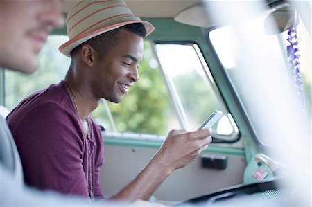 Man using cell phone in camper van Stock Photo - Premium Royalty-Free, Code: 6113-07147027