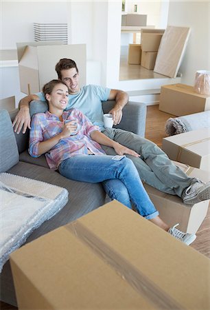 property - Couple relaxing with coffee on sofa in new house Stock Photo - Premium Royalty-Free, Code: 6113-07147191