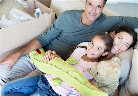 starting position - Portrait of smiling family with stuffed animals on sofa Stock Photo - Premium Royalty-Free, Code: 6113-07147207