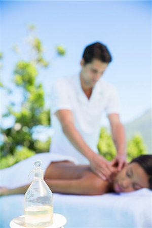 simsearch:6113-07147381,k - Woman receiving massage on spa patio Stock Photo - Premium Royalty-Free, Code: 6113-07147455