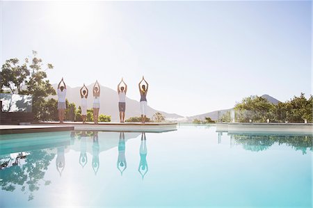 People practicing yoga at poolside Stock Photo - Premium Royalty-Free, Code: 6113-07147415