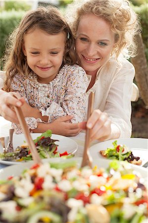 Mother and daughter eating in garden Stock Photo - Premium Royalty-Free, Code: 6113-07147648