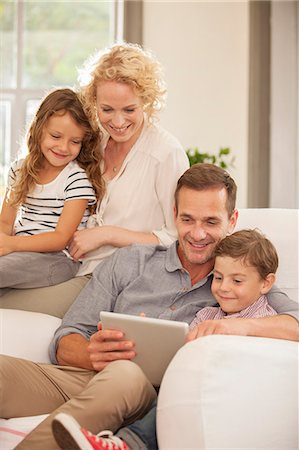 simsearch:649-07064535,k - Family using digital tablet on sofa Foto de stock - Sin royalties Premium, Código: 6113-07147668