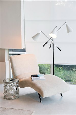 Chaise and lamp next to window Fotografie stock - Premium Royalty-Free, Codice: 6113-07147632