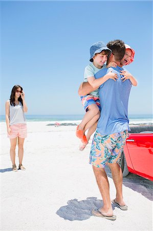 father hugging his son and daughter - Father hugging children on beach Stock Photo - Premium Royalty-Free, Code: 6113-07147748