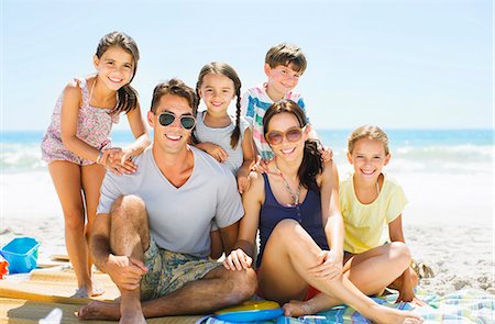 father hugging his son and daughter - Portrait of smiling family on beach Stock Photo - Premium Royalty-Free, Code: 6113-07147759