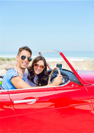 Couple driving convertible at beach Stock Photo - Premium Royalty-Free, Code: 6113-07147711