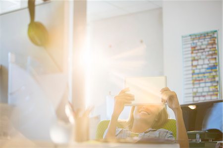 sunny work - Businesswoman using digital tablet in office Stock Photo - Premium Royalty-Free, Code: 6113-07147844