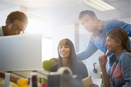 person on laptop - Business people talking at desk in office Stock Photo - Premium Royalty-Free, Code: 6113-07147871