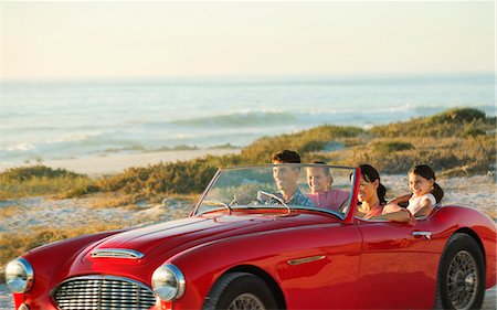 Family in convertible on beach Stock Photo - Premium Royalty-Free, Code: 6113-07147800