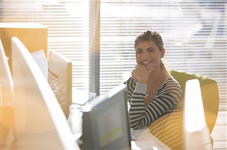 sunny work - Portrait of smiling businesswoman at desk Stock Photo - Premium Royalty-Free, Code: 6113-07147966