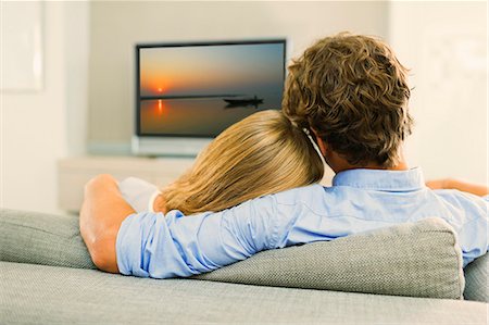 simsearch:649-06716867,k - Couple watching television on sofa Stock Photo - Premium Royalty-Free, Code: 6113-07148047