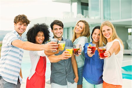 simsearch:6113-07148073,k - Friends toasting cocktails on patio Stock Photo - Premium Royalty-Free, Code: 6113-07148058