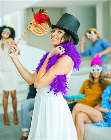 simsearch:6113-07148073,k - Woman wearing decorative hat with mask at party Stock Photo - Premium Royalty-Free, Code: 6113-07148076