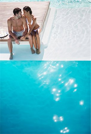 simsearch:6113-07147024,k - Couple relaxing together at poolside Stock Photo - Premium Royalty-Free, Code: 6113-07158885