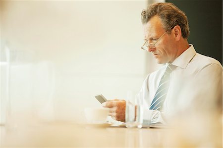 simsearch:649-07520071,k - Businessman using cell phone in cafe Stock Photo - Premium Royalty-Free, Code: 6113-07158894