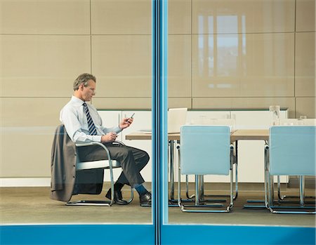 Businesswoman working at conference table Stock Photo - Premium Royalty-Free, Code: 6113-07158966