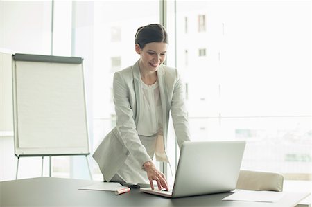 simsearch:614-08030536,k - Businesswoman using laptop in office Stock Photo - Premium Royalty-Free, Code: 6113-07158918