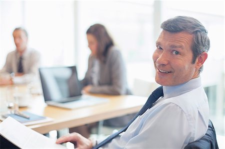 simsearch:6113-07159049,k - Businessman smiling in office Stock Photo - Premium Royalty-Free, Code: 6113-07158926