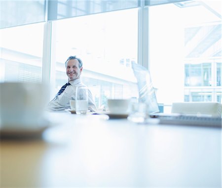 simsearch:614-08030536,k - Businessman smiling in conference room Stock Photo - Premium Royalty-Free, Code: 6113-07158928