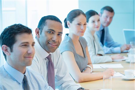 simsearch:6113-07159049,k - Business people smiling in meeting Stock Photo - Premium Royalty-Free, Code: 6113-07159052