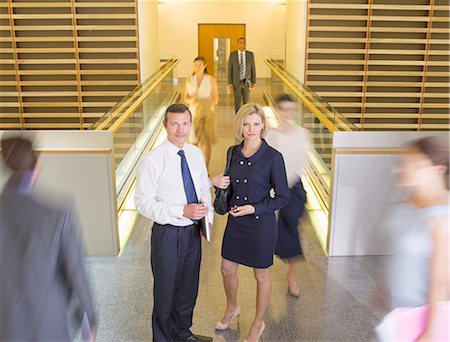 Business people in busy office corridor Stock Photo - Premium Royalty-Free, Code: 6113-07159005