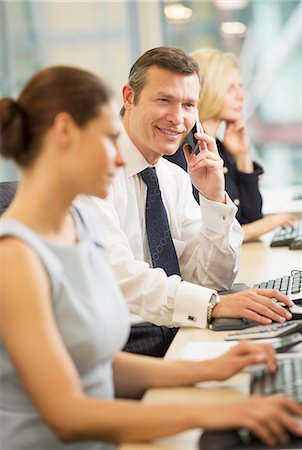 simsearch:649-07520071,k - Businessman talking on cell phone in meeting Stock Photo - Premium Royalty-Free, Code: 6113-07159013